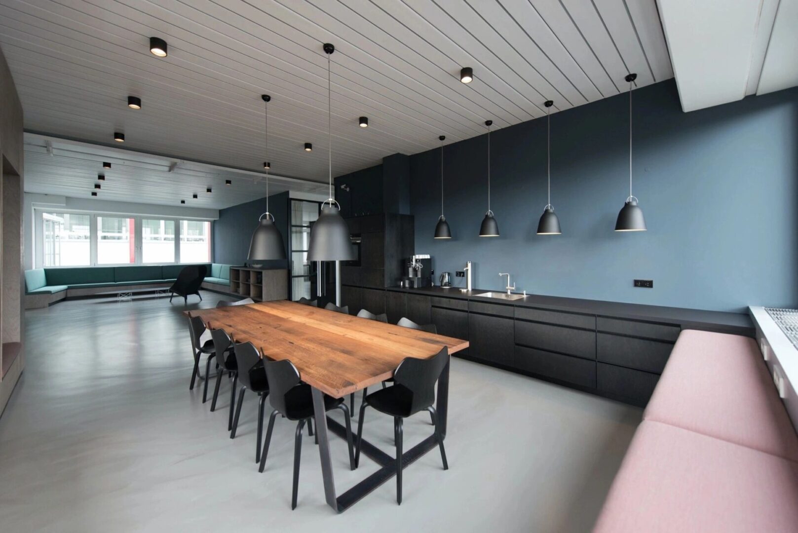 A large dining room table in the middle of a kitchen.